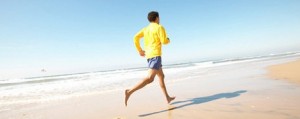 Rear view of a man running on the beach